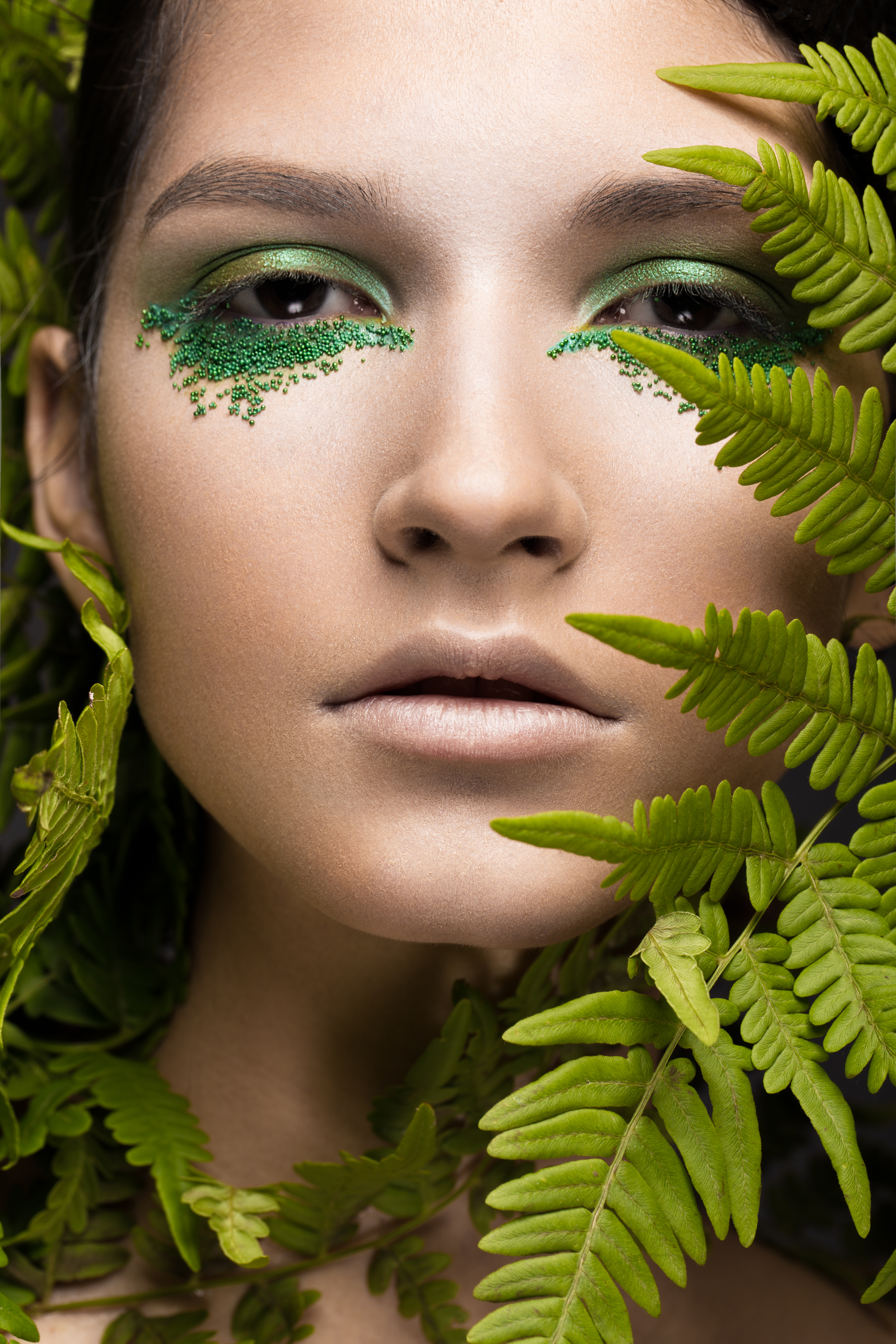 Portrait of a creator with editorial makeup and leaves